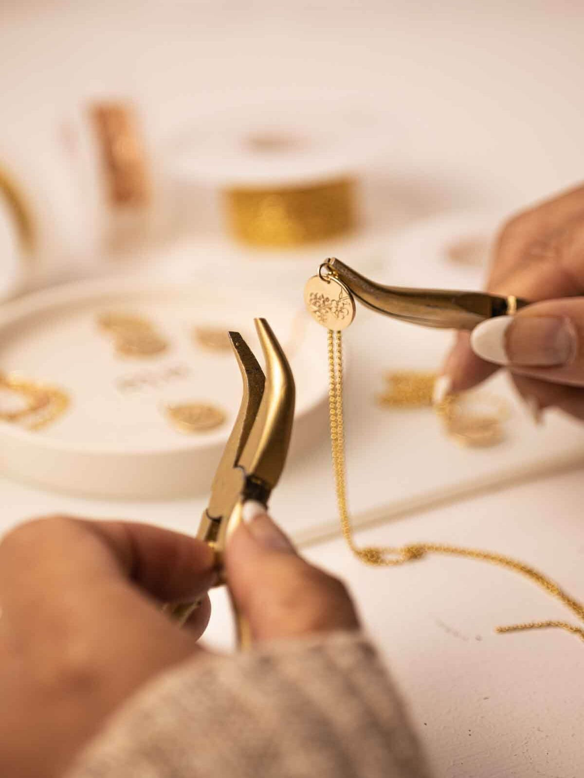 handcrafted necklace an Australian birth flower pendant being assembled with pliers